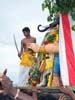 08 A young priest, representing Lord Murugan, beheads the demon Gajamukha with his sword