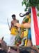 08 A young priest, representing Lord Murugan, beheads the demon Gajamukha with his sword